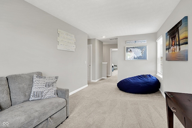 living room featuring baseboards, visible vents, and carpet