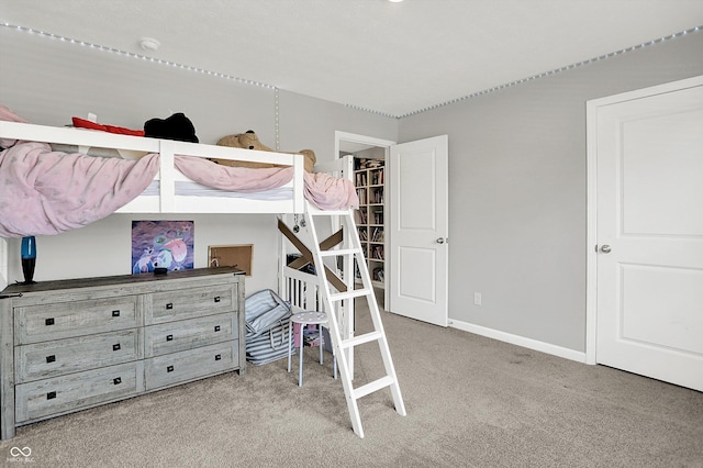 bedroom featuring baseboards and carpet
