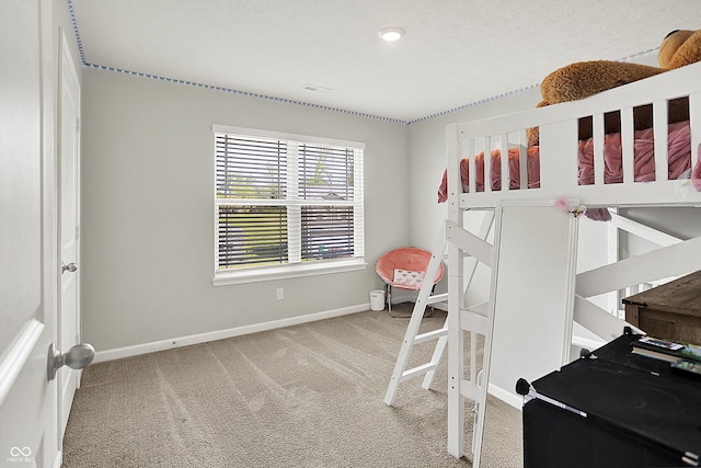 bedroom with baseboards, visible vents, and light carpet