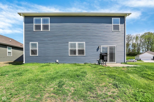 rear view of property with a yard and a patio