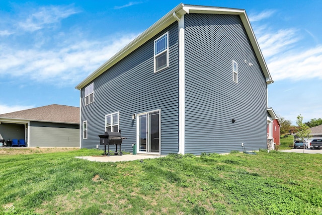 back of property featuring a lawn and a patio area