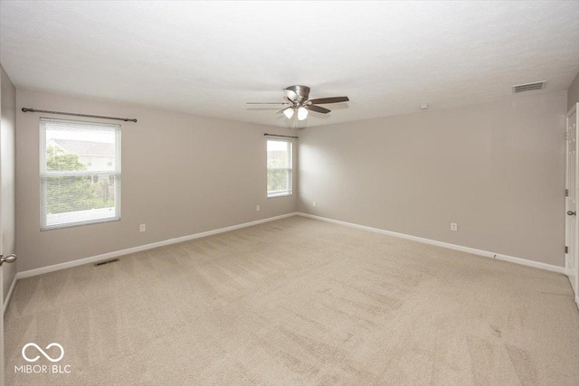 2006 Creek Bank Dr, Columbus, IN 47201 - spare room featuring a ceiling fan, baseboards, and light carpet