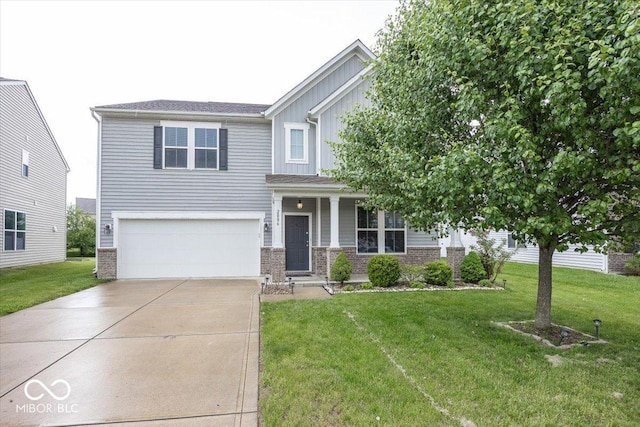 2006 Creek Bank Dr, Columbus, IN 47201 - view of front facade with a garage, concrete driveway, a front yard, board and batten siding, and brick siding
