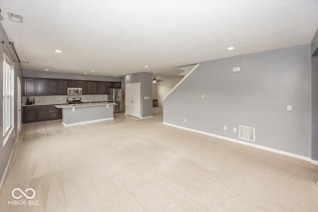 2006 Creek Bank Dr, Columbus, IN 47201 - unfurnished living room with light carpet, baseboards, recessed lighting, and ceiling fan