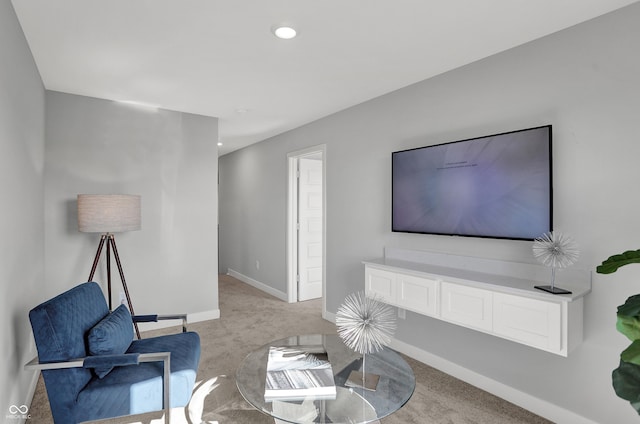 living room with recessed lighting, baseboards, and light carpet