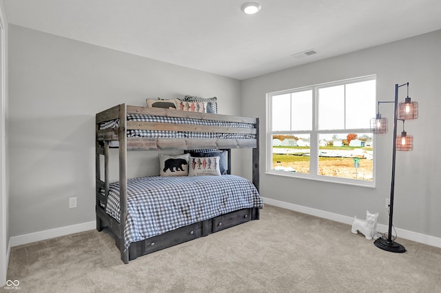 bedroom with carpet floors, baseboards, and visible vents