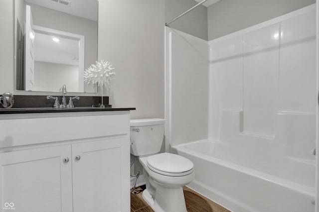 bathroom with toilet, bathtub / shower combination, wood finished floors, and vanity