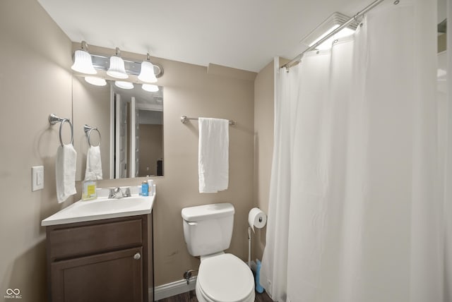 bathroom featuring vanity, toilet, and curtained shower