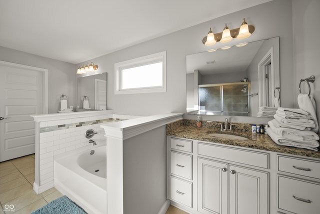 full bath featuring a garden tub, a shower with door, tile patterned floors, and vanity