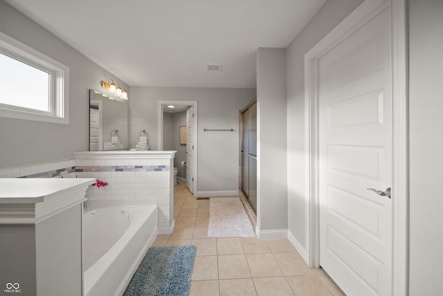 full bath with a garden tub, tile patterned flooring, a stall shower, vanity, and toilet