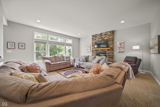 carpeted living room featuring a stone fireplace, recessed lighting, and baseboards