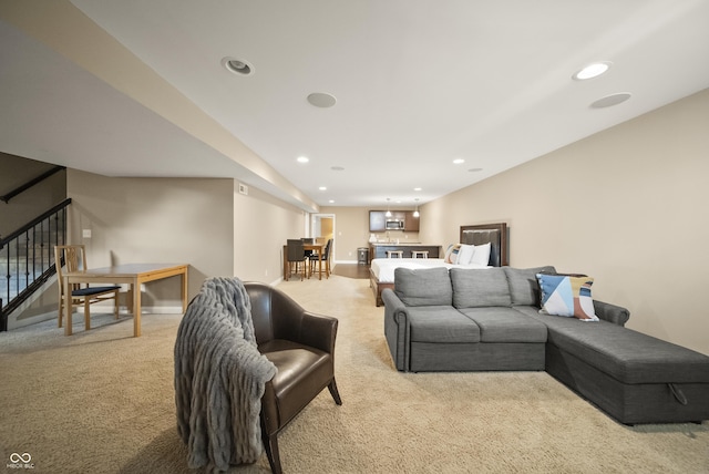 living room with recessed lighting, baseboards, light carpet, and stairway