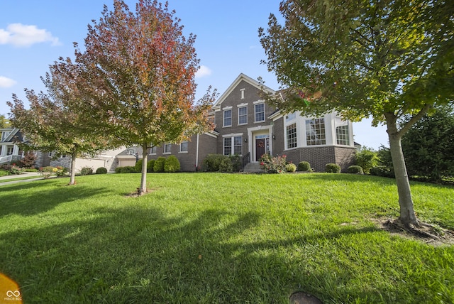 view of front of property with brick siding and a front yard
