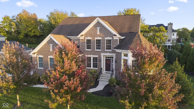 traditional-style house featuring brick siding
