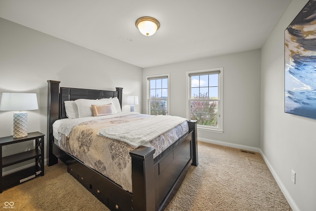 carpeted bedroom featuring baseboards and visible vents