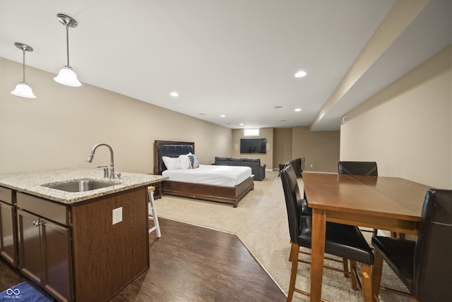 bedroom with a sink, dark colored carpet, recessed lighting, and dark wood-style flooring