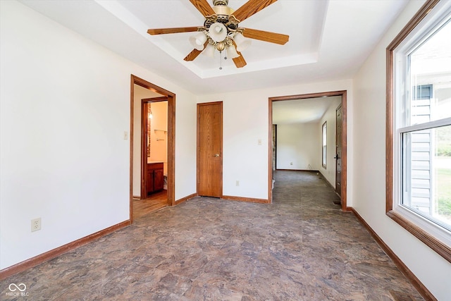 403 Hawthorn Dr, Crawfordsville, IN 47933 - unfurnished bedroom with stone finish floor, baseboards, and a raised ceiling