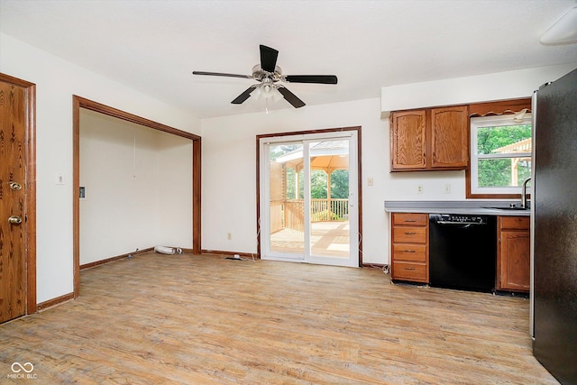 403 Hawthorn Dr, Crawfordsville, IN 47933 - kitchen with black dishwasher, a healthy amount of sunlight, and light wood-style floors