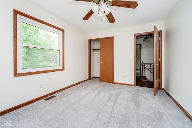 403 Hawthorn Dr, Crawfordsville, IN 47933 - unfurnished bedroom with baseboards, ceiling fan, and light carpet