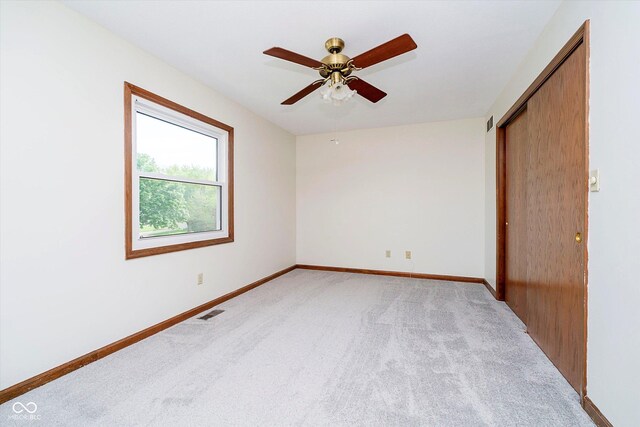 403 Hawthorn Dr, Crawfordsville, IN 47933 - empty room with visible vents, baseboards, ceiling fan, and light carpet