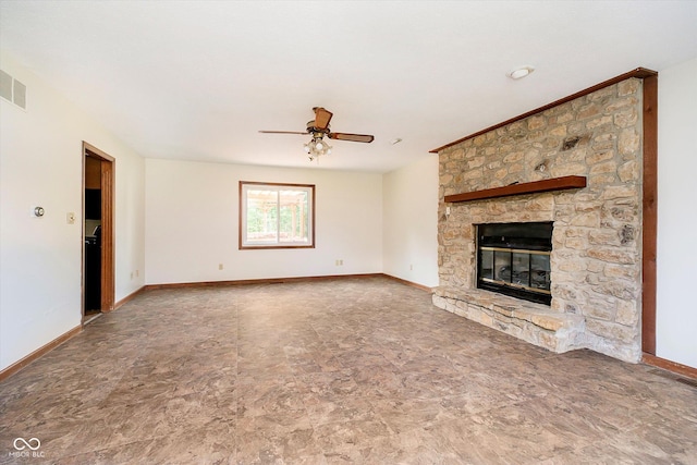 403 Hawthorn Dr, Crawfordsville, IN 47933 - unfurnished living room featuring ceiling fan, a stone fireplace, and baseboards