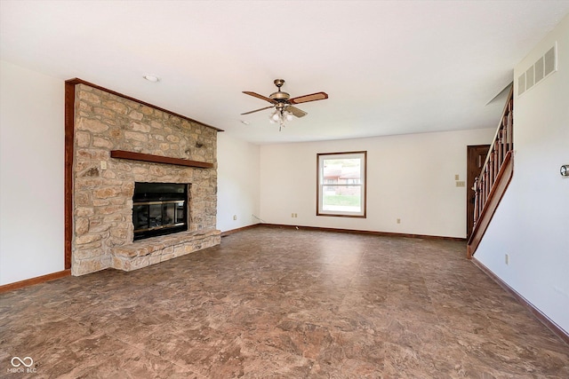403 Hawthorn Dr, Crawfordsville, IN 47933 - unfurnished living room with a ceiling fan, visible vents, a fireplace, baseboards, and stairs