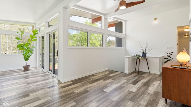 sunroom / solarium featuring a healthy amount of sunlight and visible vents