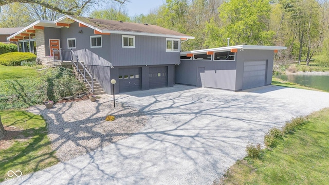 view of front of home with a garage and aphalt driveway