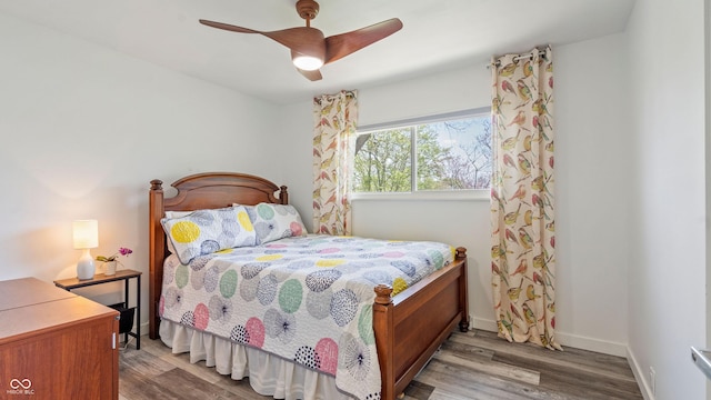 bedroom with baseboards, ceiling fan, and wood finished floors