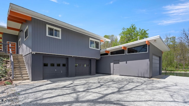 exterior space with stairway and an attached garage