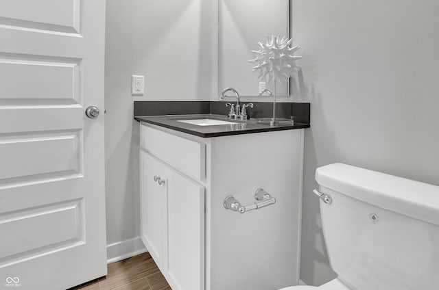 7645 Marin Pkwy, Cumberland, IN 46229 - bathroom featuring vanity, wood finished floors, and toilet