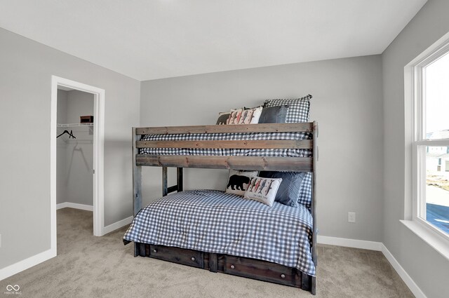 7645 Marin Pkwy, Cumberland, IN 46229 - bedroom with baseboards, a spacious closet, carpet, and a closet