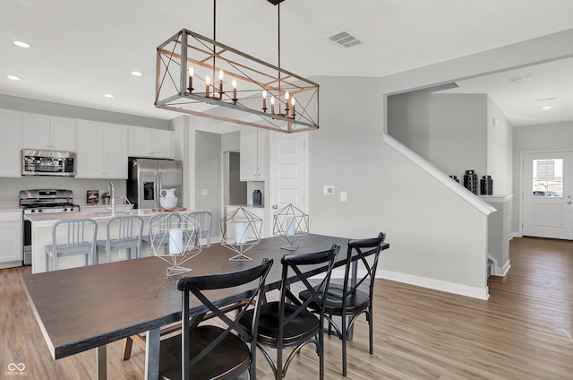 7645 Marin Pkwy, Cumberland, IN 46229 - dining space with recessed lighting, baseboards, visible vents, and light wood finished floors