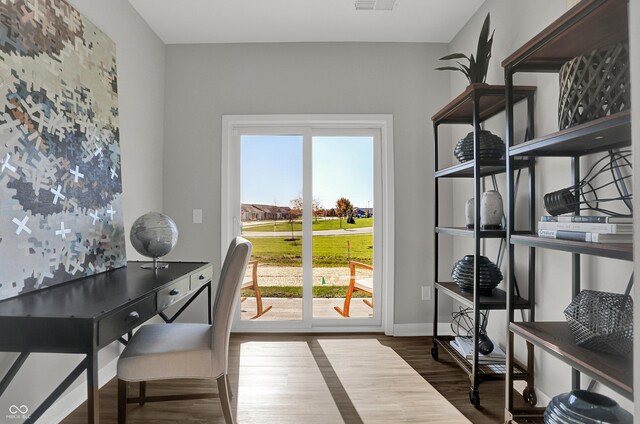7645 Marin Pkwy, Cumberland, IN 46229 - doorway to outside with baseboards, visible vents, a wealth of natural light, and wood finished floors