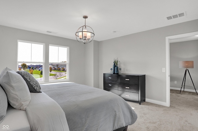7645 Marin Pkwy, Cumberland, IN 46229 - bedroom featuring light colored carpet, baseboards, visible vents, and an inviting chandelier