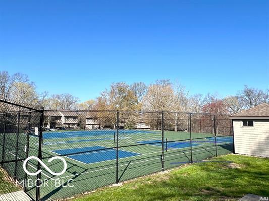 view of tennis court with fence