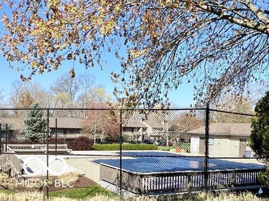 view of swimming pool featuring fence