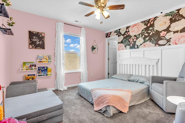 carpeted bedroom featuring baseboards, ceiling fan, and visible vents