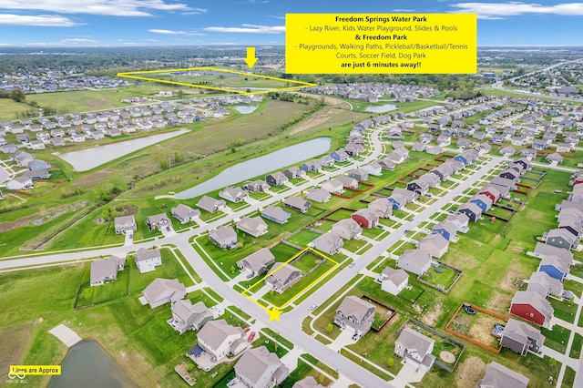 bird's eye view featuring a water view and a residential view