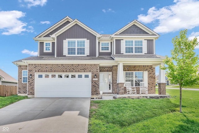 craftsman inspired home featuring a garage, fence, a front yard, concrete driveway, and a porch