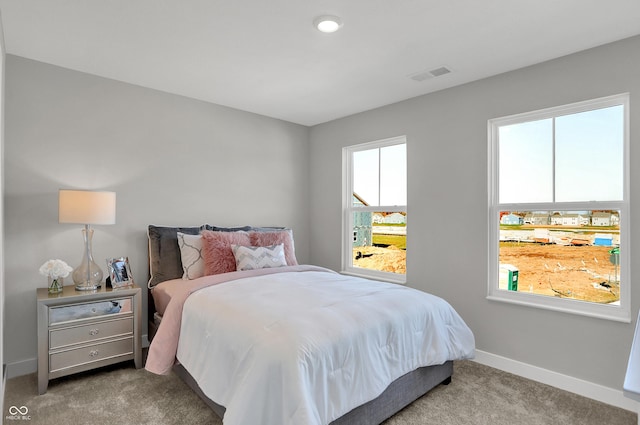 bedroom featuring baseboards, carpet flooring, and visible vents
