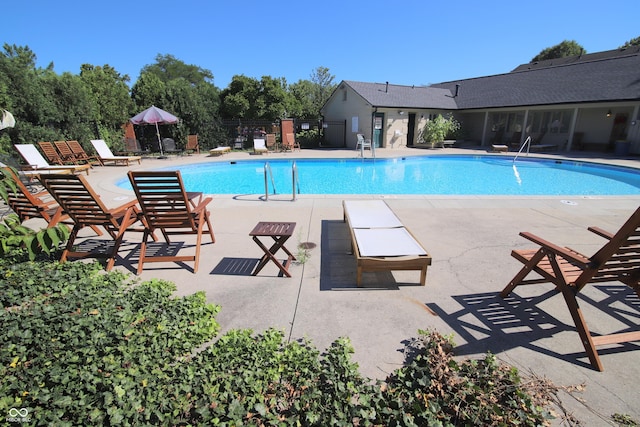pool featuring fence and a patio