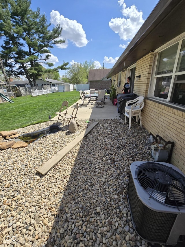 view of yard with central AC unit, a patio area, and fence