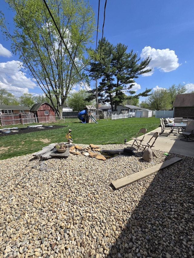 view of yard with a patio, a playground, and fence