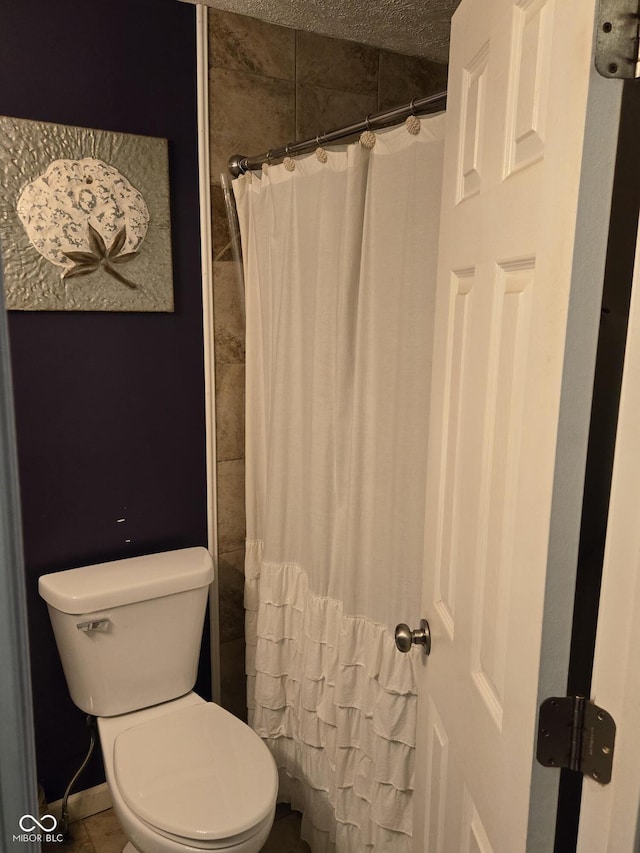 bathroom with toilet and curtained shower