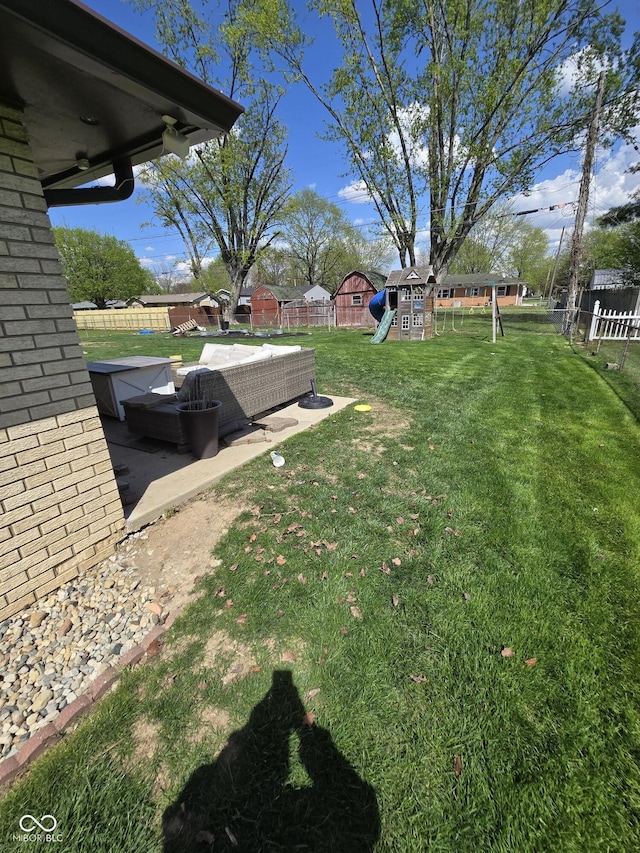 view of yard with a patio, a fenced backyard, and a playground