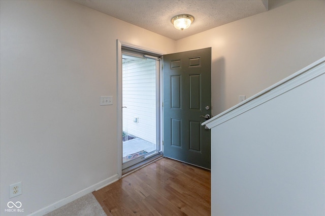 6516 Amherst Way, Zionsville, IN 46077 - entryway featuring a textured ceiling and wood finished floors