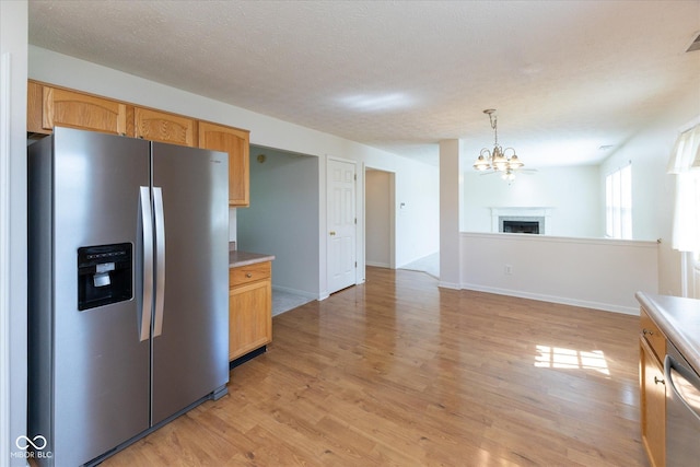 6516 Amherst Way, Zionsville, IN 46077 - kitchen featuring stainless steel appliances, light wood-style flooring, a chandelier, light countertops, and open floor plan