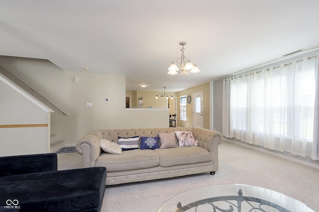 5646 Skipping Stone Dr, Indianapolis, IN 46237 - carpeted living room with a chandelier, stairs, and baseboards
