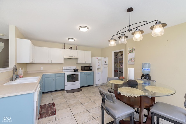 5646 Skipping Stone Dr, Indianapolis, IN 46237 - kitchen featuring white appliances, a sink, blue cabinetry, under cabinet range hood, and light countertops